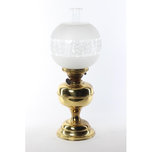 340 - An antique oil lamp with brass base & decorative etched glass shade.