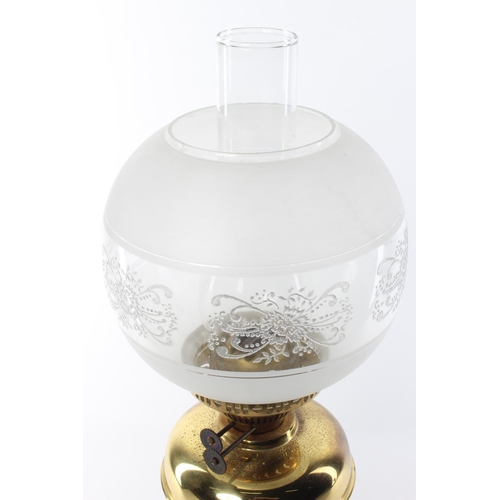 340 - An antique oil lamp with brass base & decorative etched glass shade.