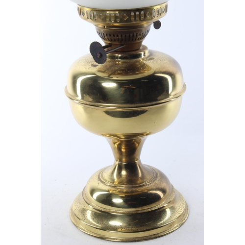 340 - An antique oil lamp with brass base & decorative etched glass shade.