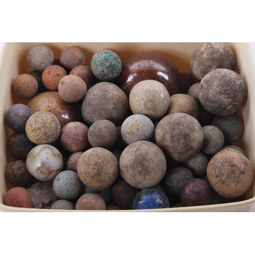 403 - A collection of antique clay marbles.