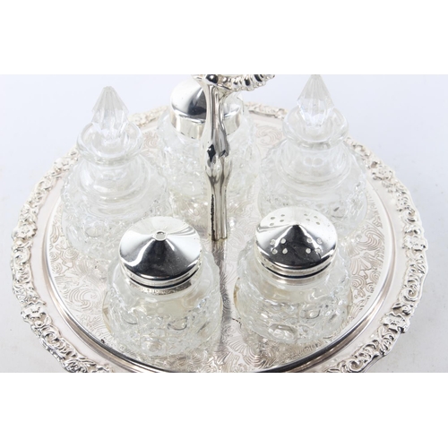 406 - A decorative antique style condiment set in silver plated holder.