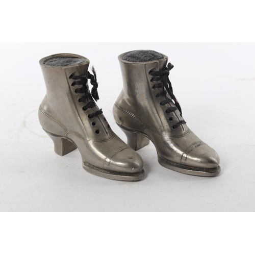 434 - A pair of vintage pewter pin cushions, modelled as boots.