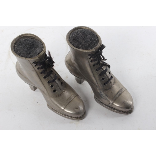 434 - A pair of vintage pewter pin cushions, modelled as boots.