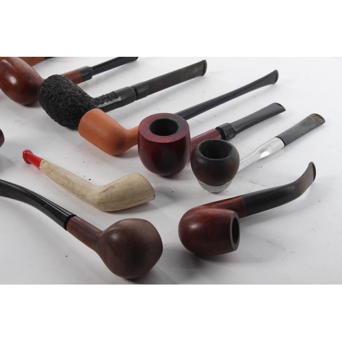 464 - A collection of various vintage and antique pipes.