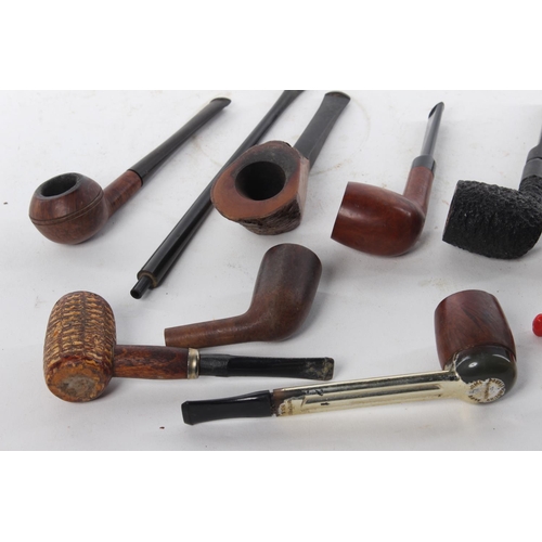 464 - A collection of various vintage and antique pipes.