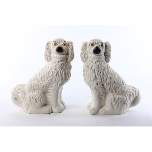 467 - A pair of antique Staffordshire Spaniels. Approx 29cm tall.