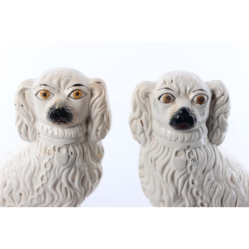 467 - A pair of antique Staffordshire Spaniels. Approx 29cm tall.