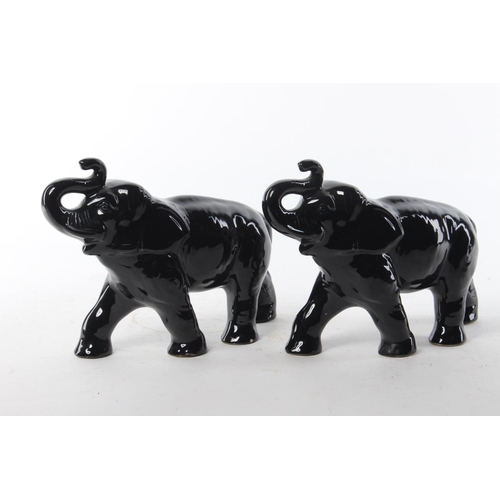 470 - A pair of antique ceramic elephants. Each 20x16cm.