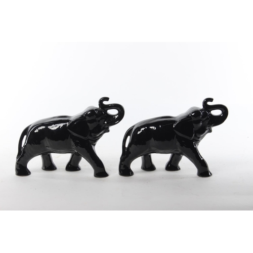 470 - A pair of antique ceramic elephants. Each 20x16cm.