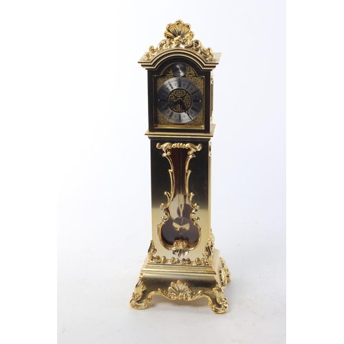 484 - A brass clock, modelled as a grandfather clock.