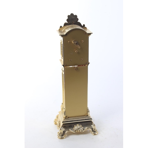 484 - A brass clock, modelled as a grandfather clock.