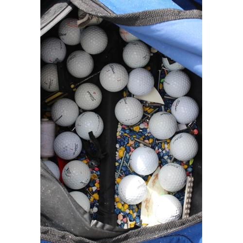 523 - An assortment of golf balls in bag.