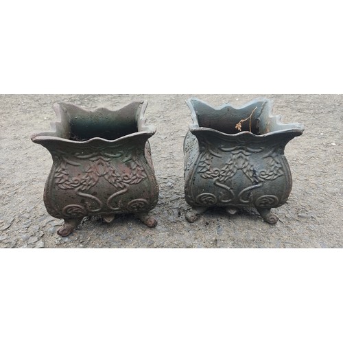 534B - A small pair of antique cast metal planters.