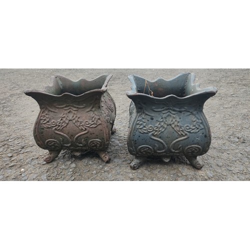 534B - A small pair of antique cast metal planters.