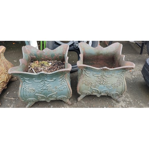 534C - A pair of antique cast iron planters.