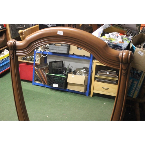 263 - A large decorative mirror in wood effect frame. Approx 106x92cm.