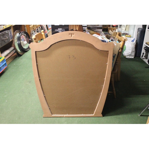 263 - A large decorative mirror in wood effect frame. Approx 106x92cm.