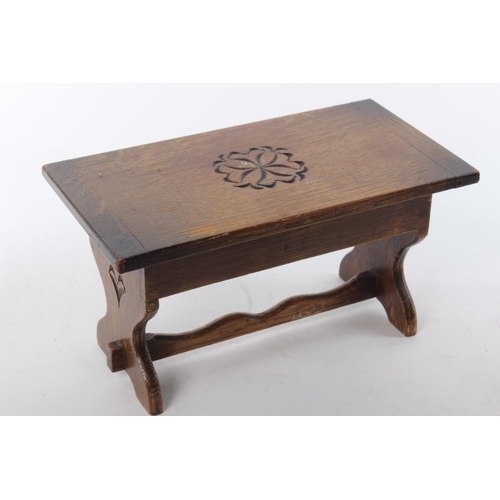 379 - A small handmade carved trinket box, modelled as a wooden stool.