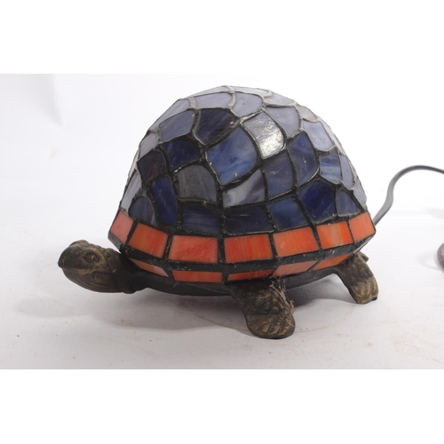 13 - A tortoise table lamp with stained glass shade.