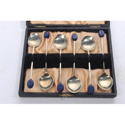 39 - A cased set of coffee bean spoons.