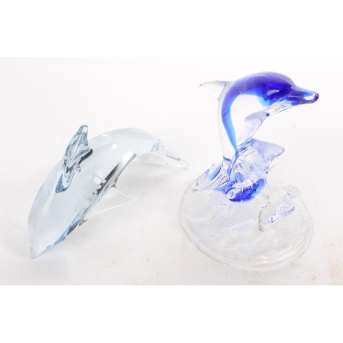 56 - 2 glass dolphin figures.