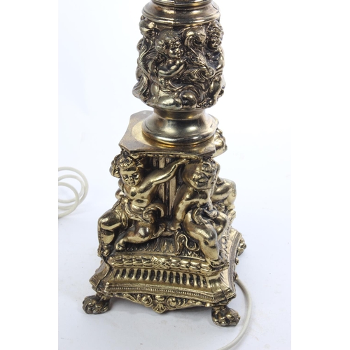 73 - An antique/ vintage brass table lamp base with Cherub decoration, measuring 62cm tall.