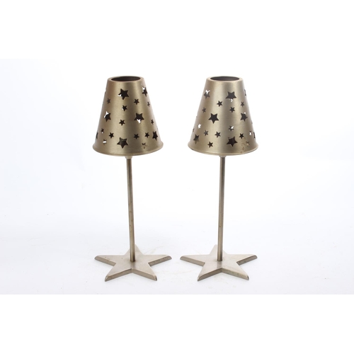 75 - A pair of decorative metal candleholders with shades.