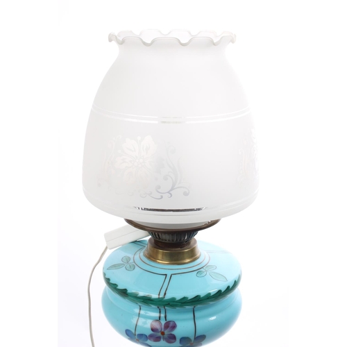 76 - An antique oil lamp with painted glass font & etched shade, which has been converted to electric. Me... 