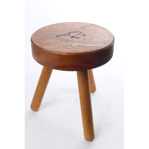 518 - A handmade 3 legged wooden stool with carved design to seat.