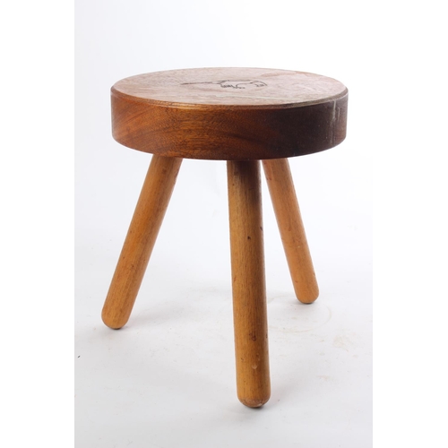 518 - A handmade 3 legged wooden stool with carved design to seat.