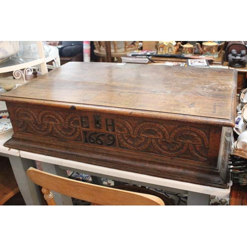 540 - A stunning large antique carved oak Bible box, reading 'E H - 1669', measuring 82x51x20cm.