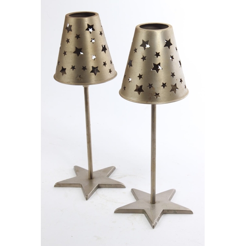 75 - A pair of decorative metal candleholders with shades.