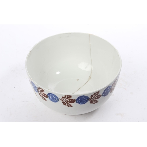 204 - An antique Belleek Sponge Ware bowl, with a good solid pattern of blue and brown sponge (a/f).