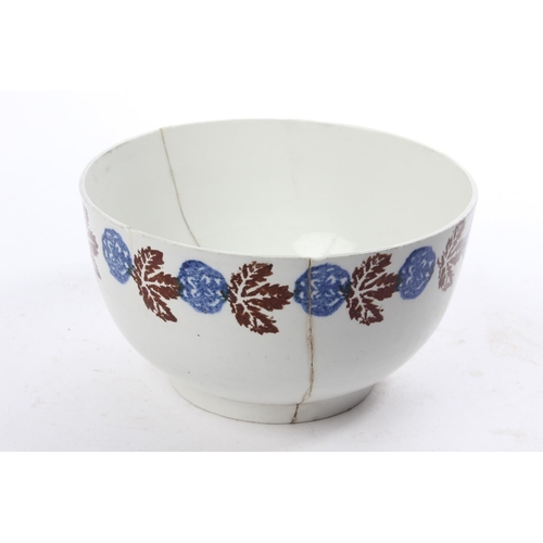 204 - An antique Belleek Sponge Ware bowl, with a good solid pattern of blue and brown sponge (a/f).