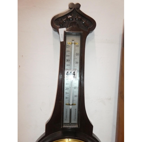 444 - An oak cased barometer. Measuring 74cm tall.