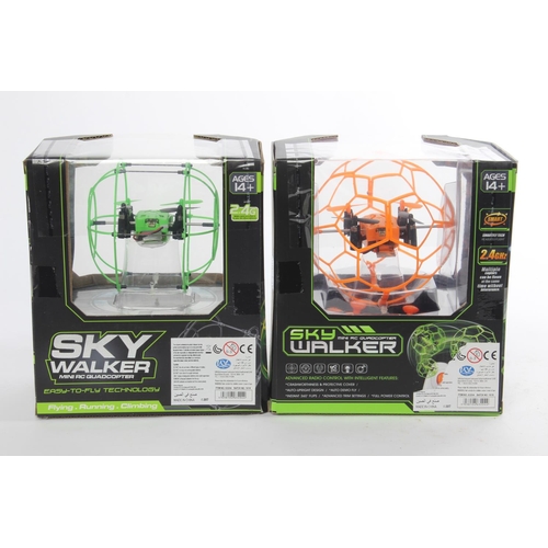 13 - Two boxed Sky Walker mini RC quadcopters.