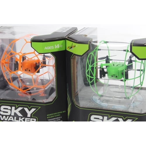 13 - Two boxed Sky Walker mini RC quadcopters.