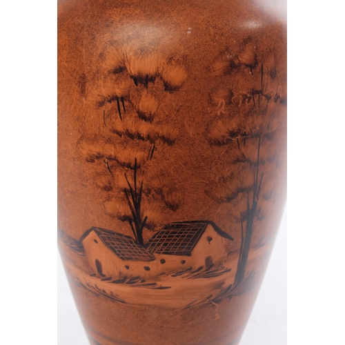 287 - A terracotta vase with hand painted detail.