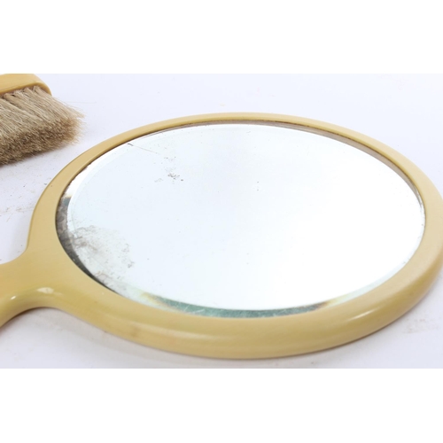 307 - A vintage vanity mirror and brush set.