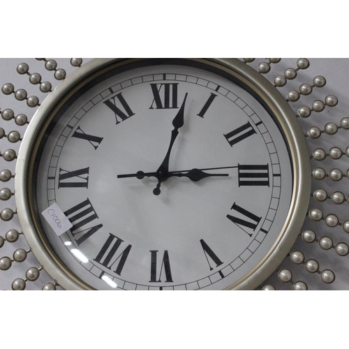 391 - A decorative wall clock with pearl detail.