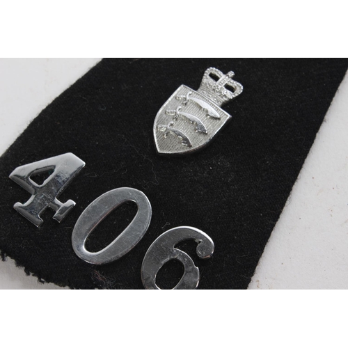 398 - Two '406' military fabric badges.