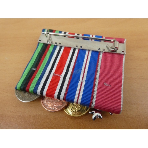 443 - A set of four miniature medals to include an RUC Service Medal, an Ulster Special Constabulary Long ... 