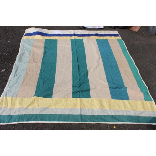 646 - An Irish linen green, yellow and beige patchwork quilt. Measuring 66x73inches.