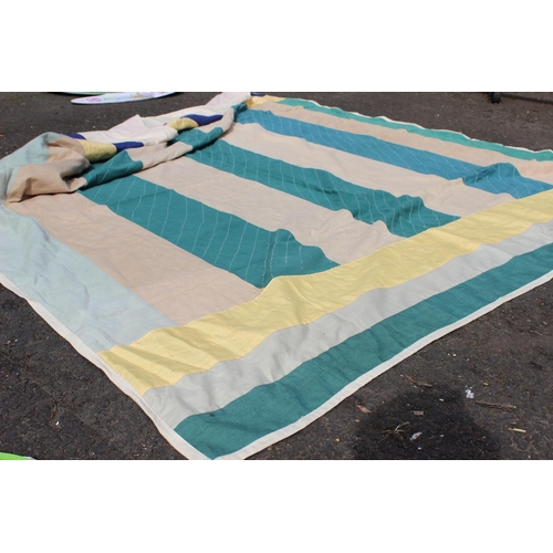 646 - An Irish linen green, yellow and beige patchwork quilt. Measuring 66x73inches.