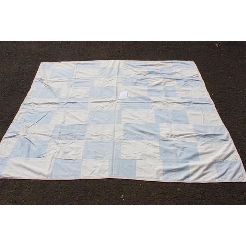 654 - A handmade large blue and white rectangular patchwork quilt. Measuring 68x74inches.