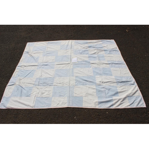 654 - A handmade large blue and white rectangular patchwork quilt. Measuring 68x74inches.