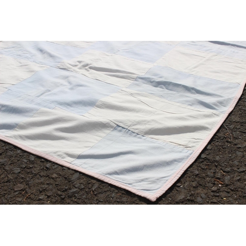 654 - A handmade large blue and white rectangular patchwork quilt. Measuring 68x74inches.