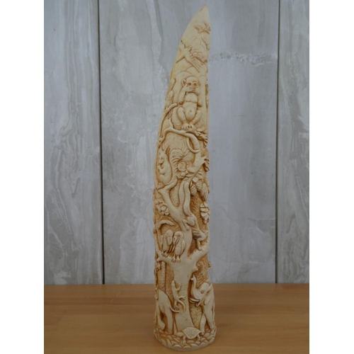 675 - A resin tusk with decoratively carved details.