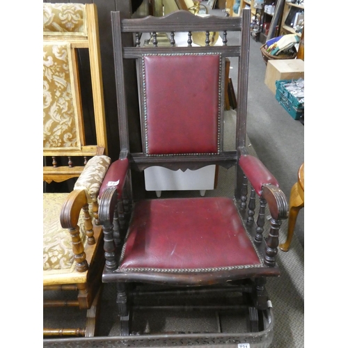 725 - An American-style rocking chair with red leather upholstery.