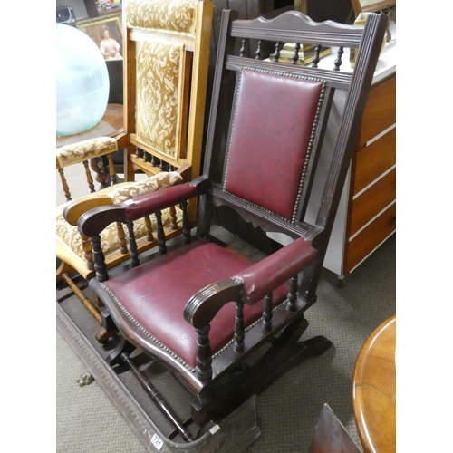 725 - An American-style rocking chair with red leather upholstery.